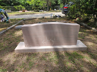 Curved granite monument with base — after cleaning