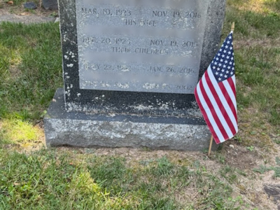 Family memorial headstone with engraved dates — before cleaning