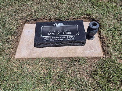 Flat granite grave marker with vase — after cleaning