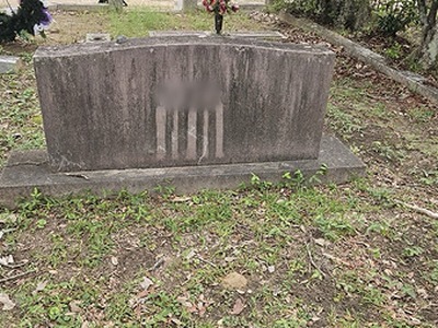 Curved granite monument with base — before cleaning