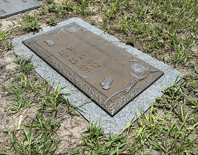 Bronze plaque on granite base — before cleaning