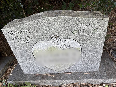 Upright granite headstone with heart engraving — before cleaning